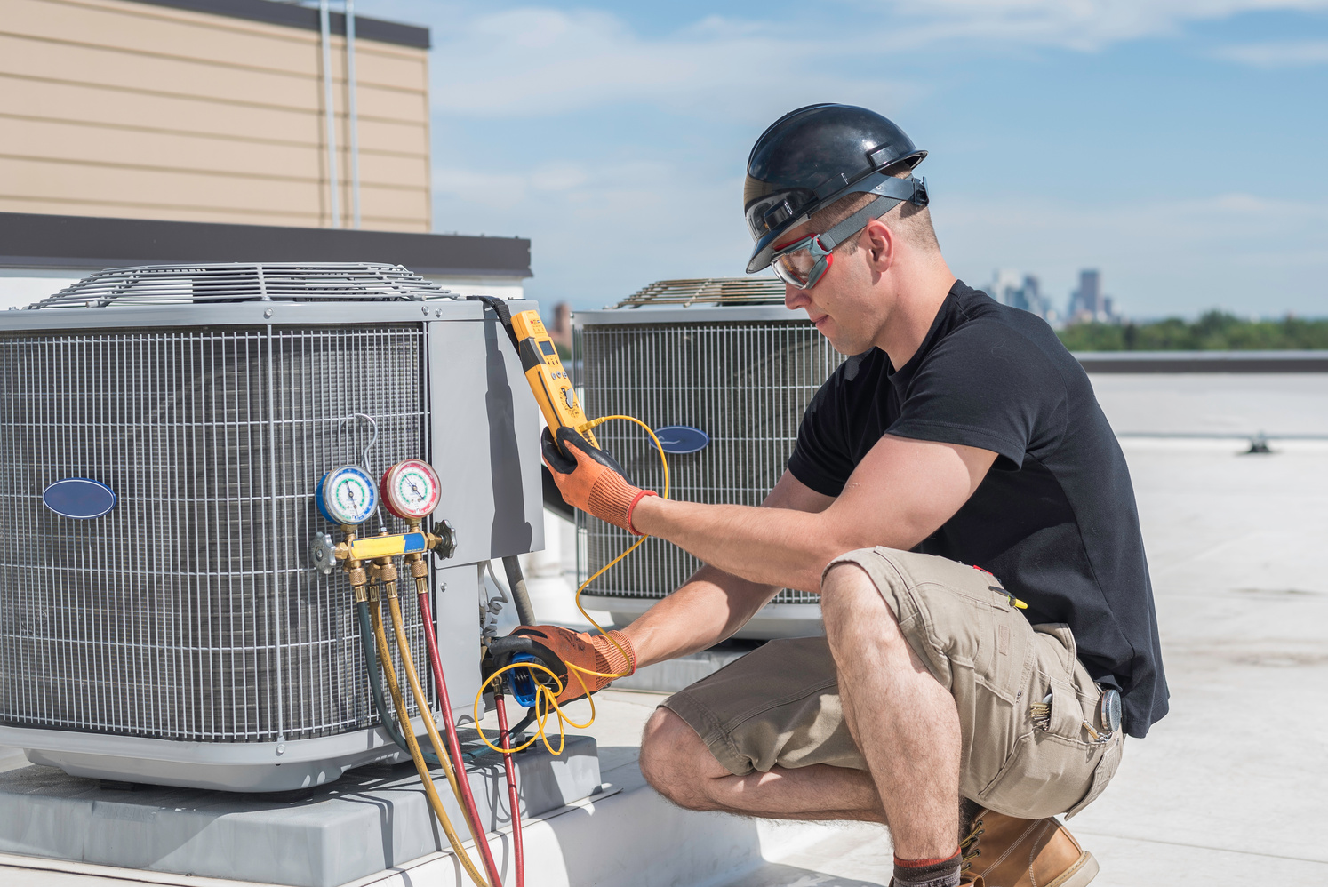 Hvac Tech reading a multimeter